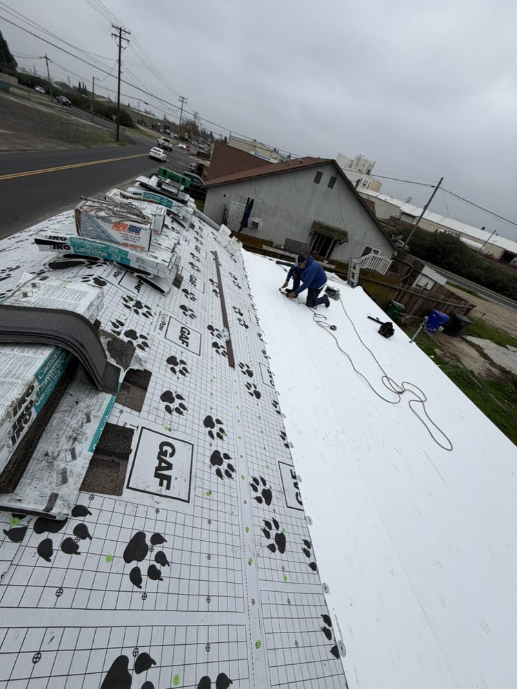 Roofing contractor Knoxville TN: crew installing a low-slope roof membrane